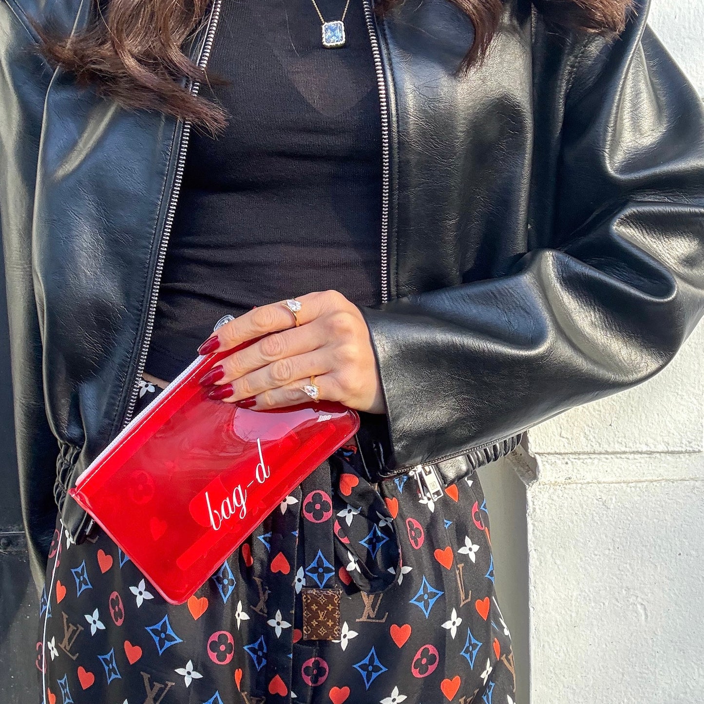 model holds bagd_everything_pouch_red_tpu_front.